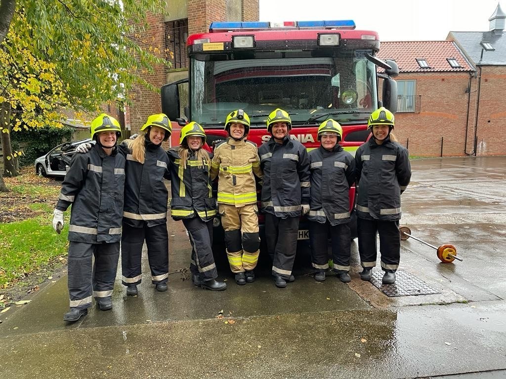 Careers becoming a firefight firefighter at recruitment event in front of a fire engine